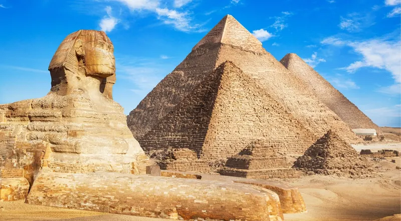 The Great Sphinx of Giza in profile with the Pyramid of Khafre rising behind it